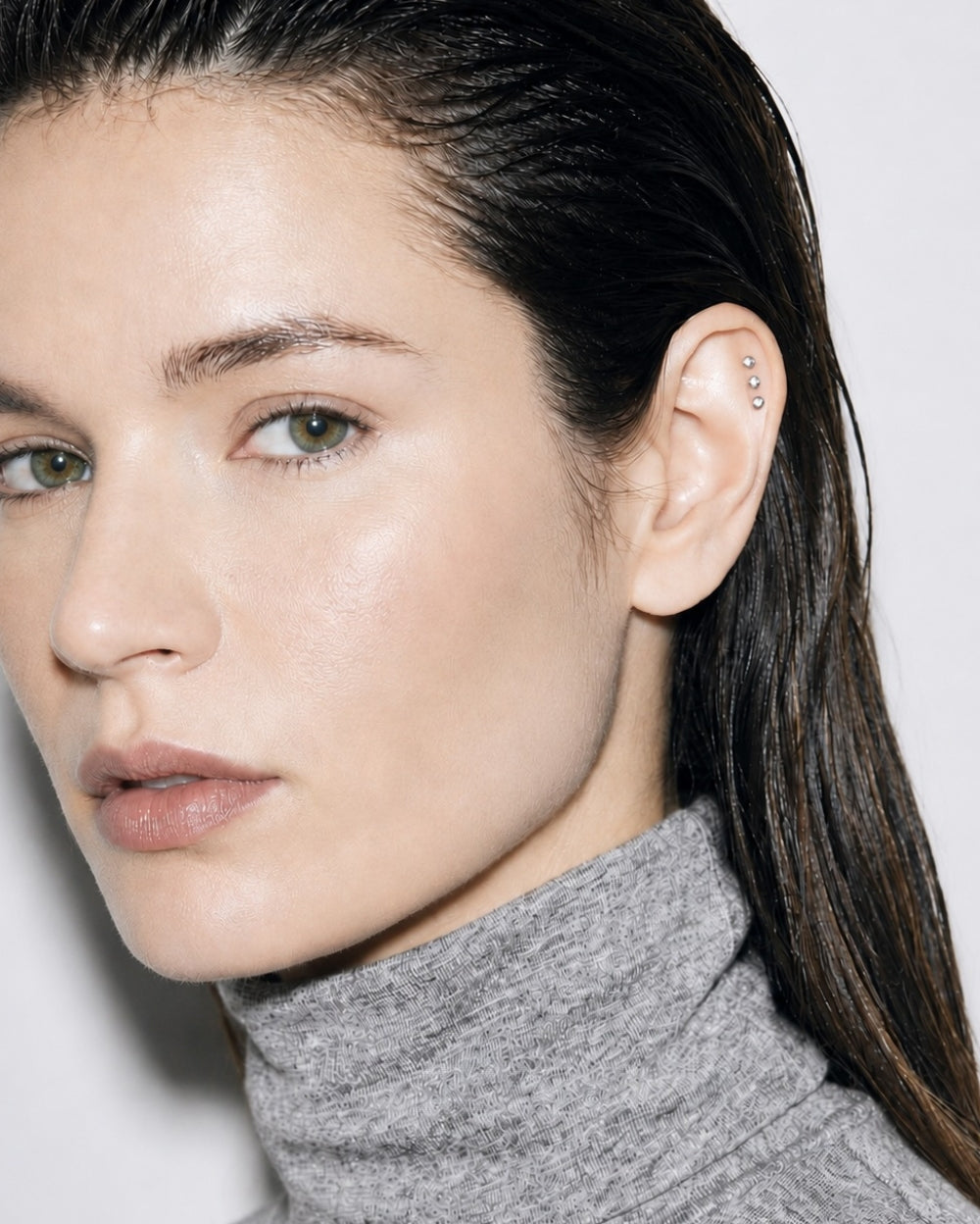 Three Silver Disc earrings on model 