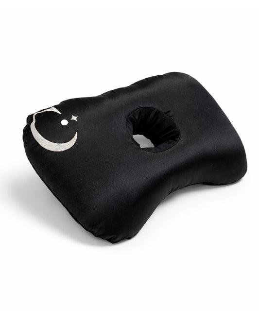Black ear piercing pillow with hole for ear and a logo design