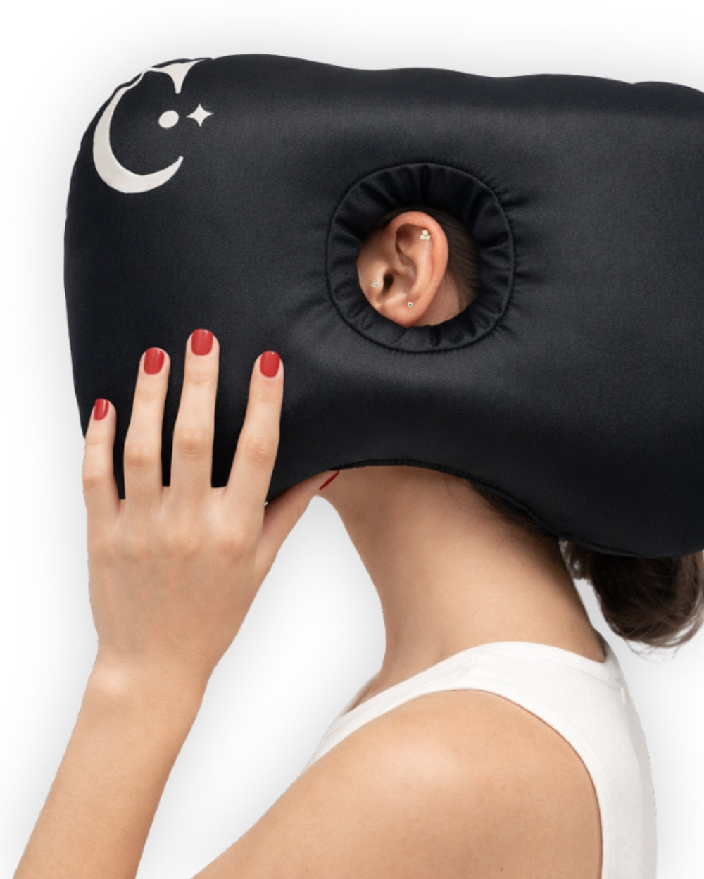 Black Covetear ear piercing pillow with hole for ear  held by a person with a logo design