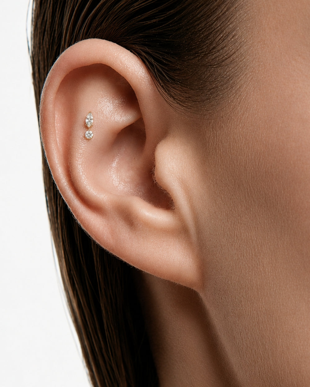 Ear with marquise and round diamond earring in flat of ear.