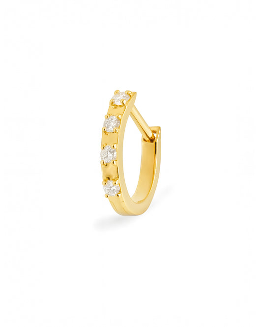 Gold Covetear hoop earring with small diamonds on a white background